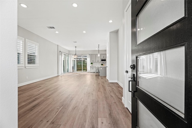 foyer entrance featuring visible vents, baseboards, recessed lighting, and light wood-style floors