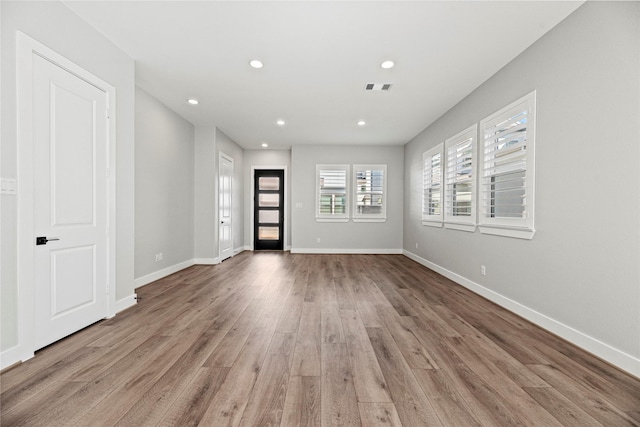 interior space featuring baseboards, recessed lighting, visible vents, and light wood-type flooring