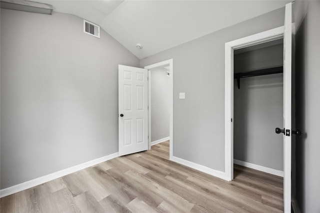 6810 Cohn St, Houston, TX 77091 - unfurnished bedroom featuring a closet, lofted ceiling, visible vents, and wood finished floors