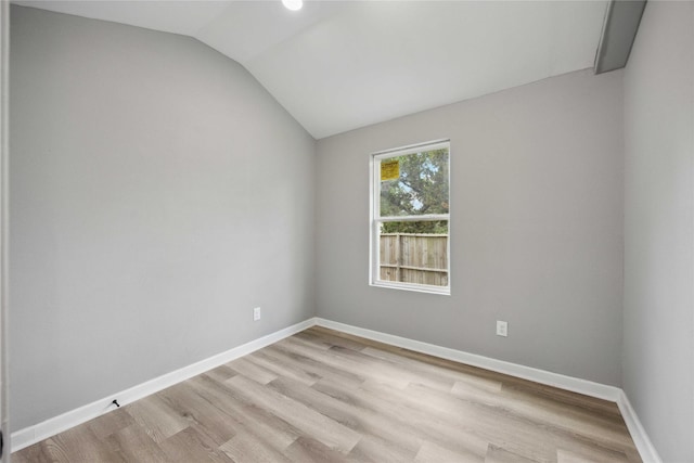 6810 Cohn St, Houston, TX 77091 - spare room featuring lofted ceiling, baseboards, and light wood finished floors