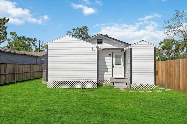 6810 Cohn St, Houston, TX 77091 - back of house featuring a fenced backyard, a yard, and entry steps