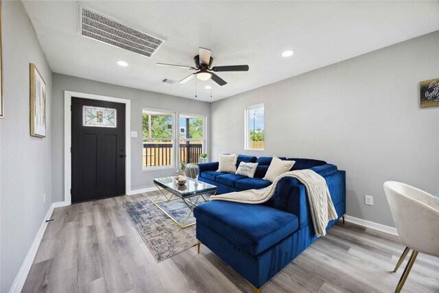 6810 Cohn St, Houston, TX 77091 - living room featuring light wood-type flooring, baseboards, and visible vents