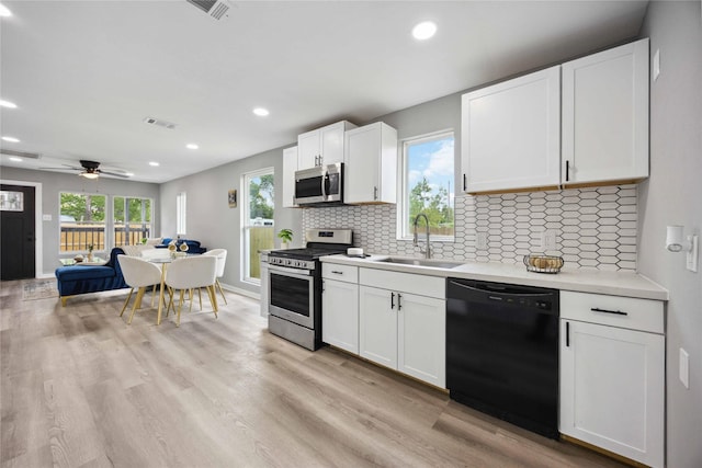 6810 Cohn St, Houston, TX 77091 - kitchen featuring visible vents, a sink, recessed lighting, and appliances with stainless steel finishes