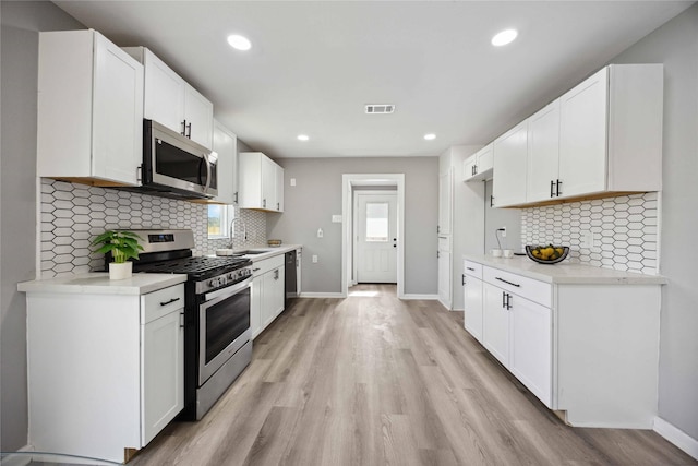 6810 Cohn St, Houston, TX 77091 - kitchen featuring baseboards, visible vents, a sink, and appliances with stainless steel finishes