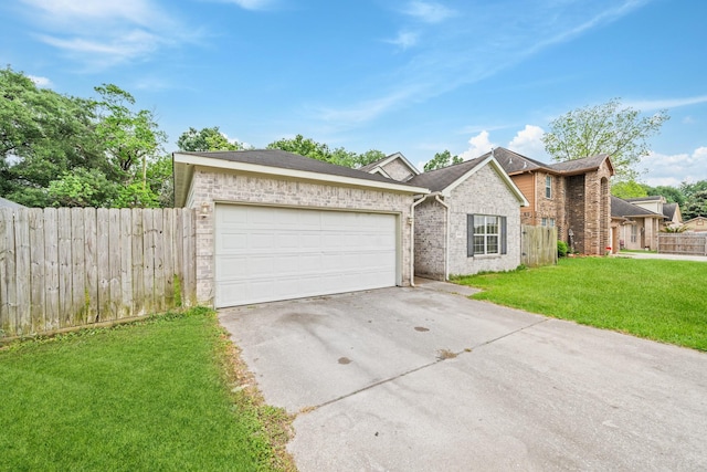 ranch-style home with driveway, fence, a front yard, a garage, and brick siding