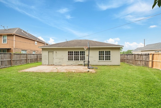 rear view of property with a lawn, a fenced backyard, and a patio
