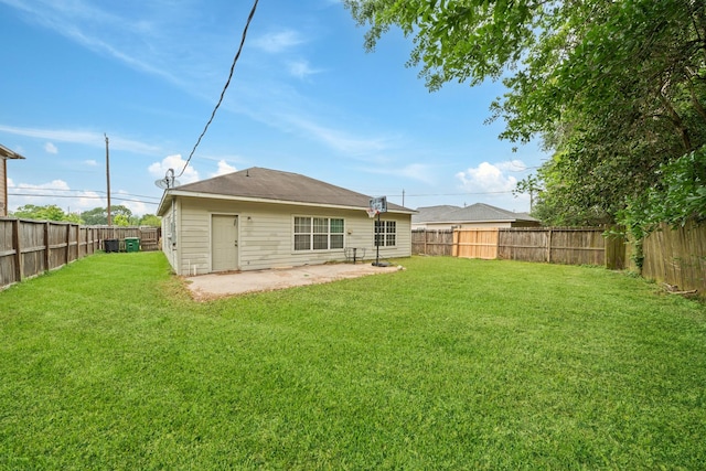 back of property featuring a patio area, a lawn, and a fenced backyard