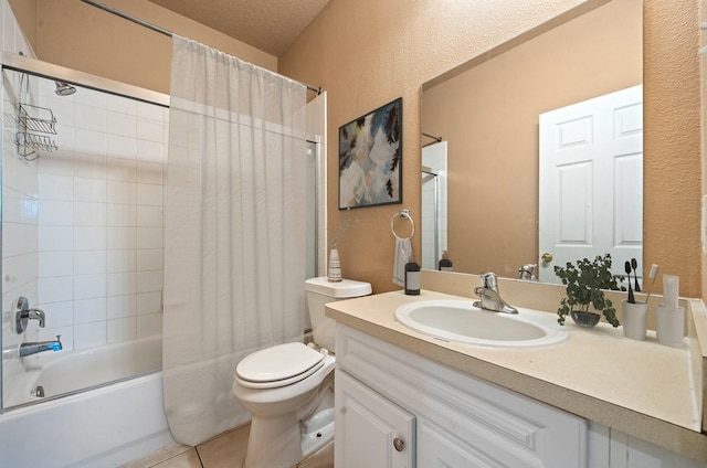 bathroom with vanity, shower / bath combo with shower curtain, tile patterned floors, toilet, and a textured wall