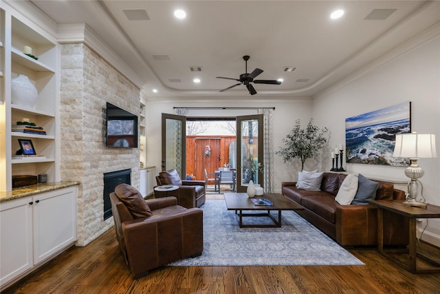 5021 Augusta St, Houston, TX 77007 - living area with ornamental molding, a ceiling fan, dark wood-style floors, and a stone fireplace