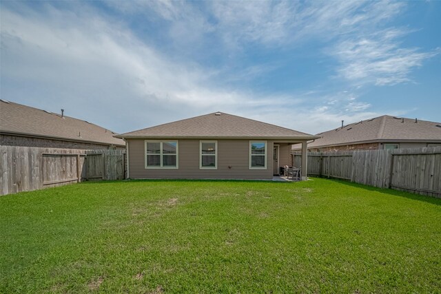 515 Green Clover Ln, Rosharon, TX 77583 - rear view of property featuring a lawn, a fenced backyard, and a patio