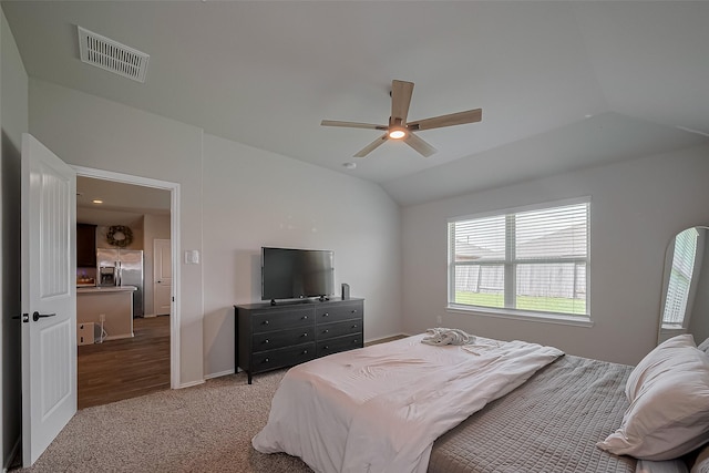 515 Green Clover Ln, Rosharon, TX 77583 - bedroom with carpet, vaulted ceiling, visible vents, stainless steel refrigerator with ice dispenser, and ceiling fan