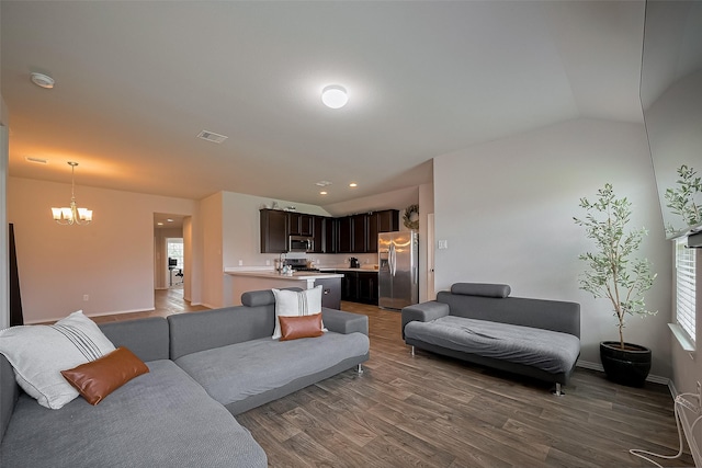 515 Green Clover Ln, Rosharon, TX 77583 - living room with vaulted ceiling, visible vents, baseboards, a notable chandelier, and dark wood-type flooring