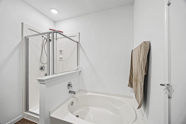bathroom with a bath and a stall shower