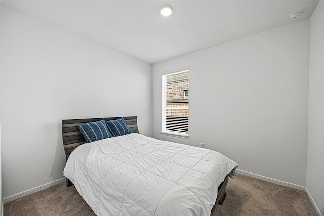 bedroom with baseboards and carpet floors
