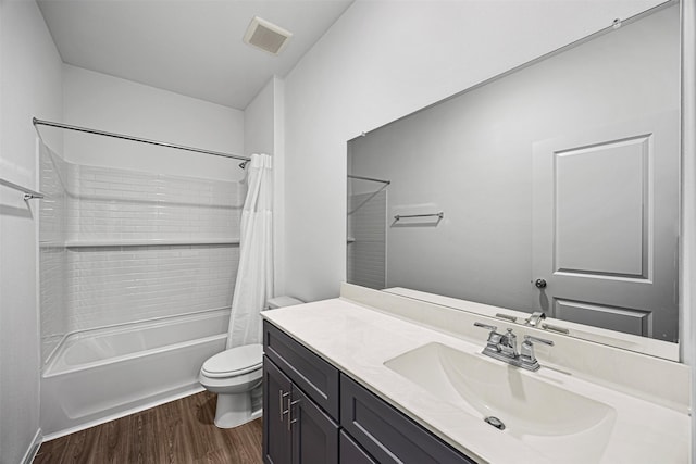 bathroom featuring wood finished floors, visible vents, toilet, vanity, and shower / bath combo with shower curtain
