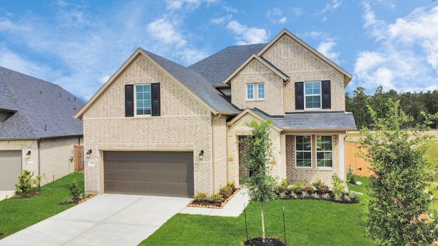 15607 Boulder Lake Ln, Conroe, TX 77302 - view of front of home with driveway, a garage, brick siding, and a front yard