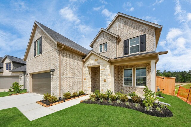 15607 Boulder Lake Ln, Conroe, TX 77302 - traditional-style home featuring an attached garage, brick siding, driveway, and a front yard