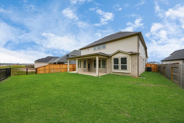 15607 Boulder Lake Ln, Conroe, TX 77302 - back of house featuring a lawn, a patio, brick siding, and a fenced backyard