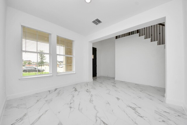 15607 Boulder Lake Ln, Conroe, TX 77302 - empty room featuring baseboards, marble finish floor, and visible vents