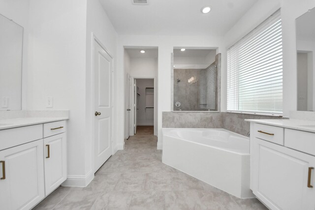 15607 Boulder Lake Ln, Conroe, TX 77302 - full bathroom featuring tiled shower, vanity, recessed lighting, and a bath