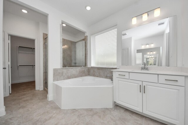 15607 Boulder Lake Ln, Conroe, TX 77302 - bathroom featuring recessed lighting, visible vents, a shower stall, a garden tub, and vanity