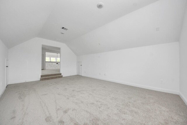 15607 Boulder Lake Ln, Conroe, TX 77302 - bonus room with vaulted ceiling, carpet floors, baseboards, and visible vents