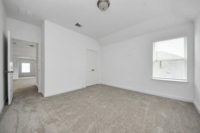 15607 Boulder Lake Ln, Conroe, TX 77302 - unfurnished bedroom with baseboards, carpet flooring, visible vents, and vaulted ceiling