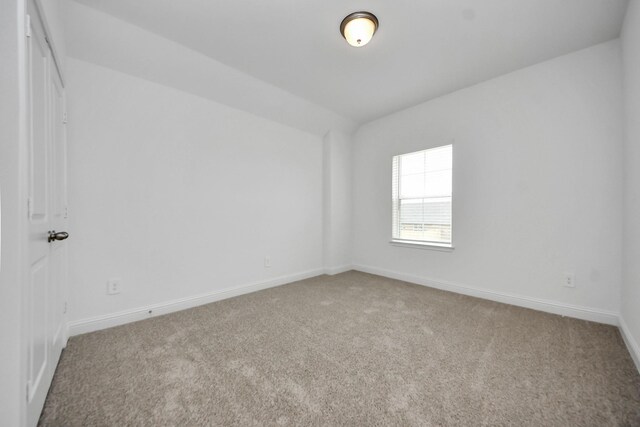 15607 Boulder Lake Ln, Conroe, TX 77302 - carpeted spare room featuring vaulted ceiling and baseboards