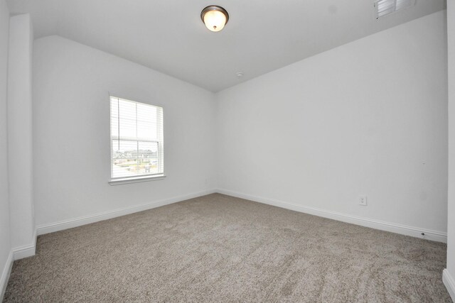 15607 Boulder Lake Ln, Conroe, TX 77302 - carpeted spare room with vaulted ceiling, baseboards, and visible vents