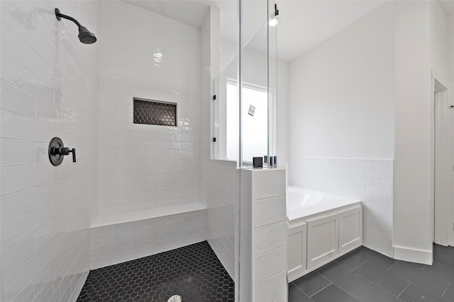 4519 Teton St, Houston, TX 77051 - full bathroom with tile walls, a wainscoted wall, tile patterned floors, and tiled shower