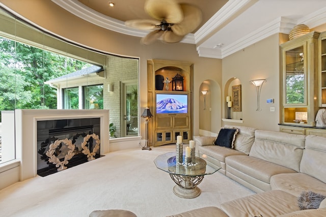 17511 Seidel Rd, Tomball, TX 77377 - living room with a fireplace, ceiling fan, and crown molding