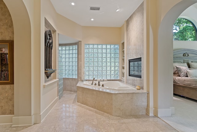 17511 Seidel Rd, Tomball, TX 77377 - full bath featuring visible vents, ensuite bath, baseboards, a garden tub, and built in shelves