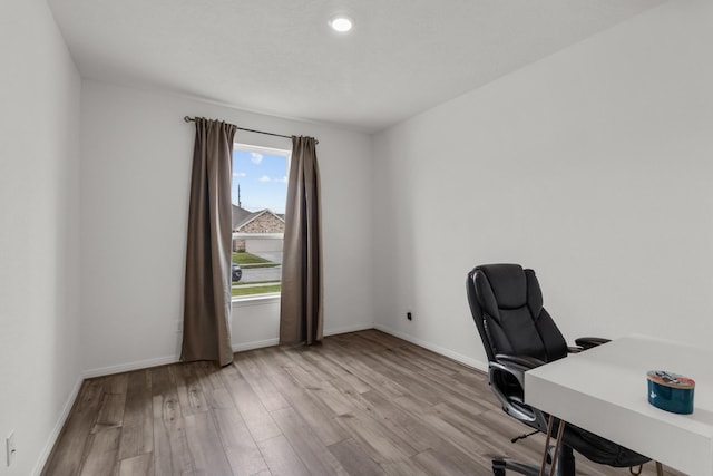 office space with baseboards and wood finished floors
