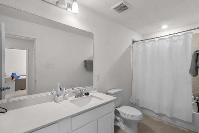 bathroom with visible vents, tile patterned flooring, shower / tub combo, vanity, and toilet