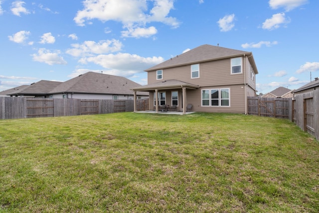 rear view of property with a lawn, a fenced backyard, and a patio area