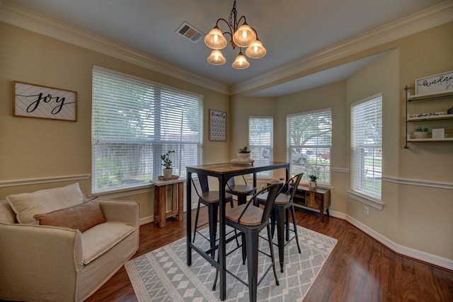 dining area featuring baseboards, dark wood-style floors, an inviting chandelier, and crown molding