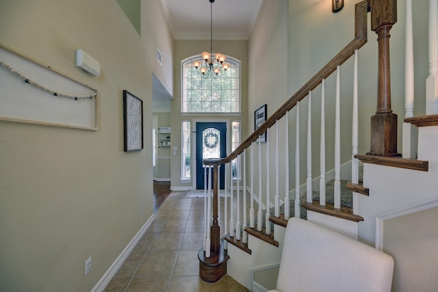 entrance foyer featuring visible vents, a chandelier, baseboards, stairway, and a high ceiling
