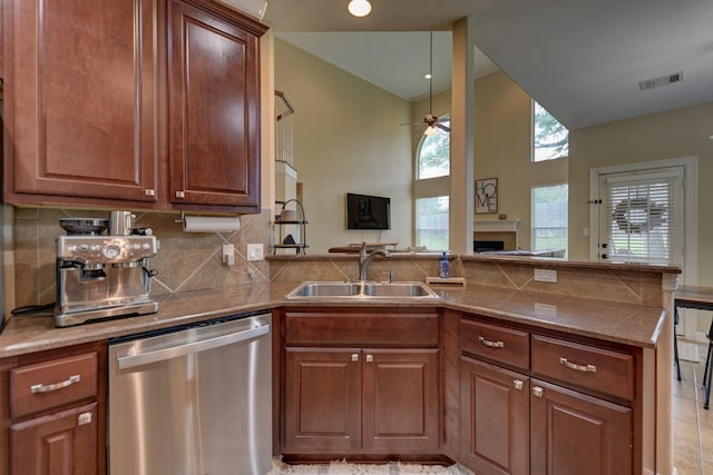 kitchen featuring a sink, a fireplace, ceiling fan, visible vents, and stainless steel dishwasher