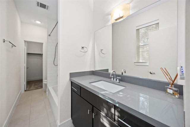 full bath featuring baseboards, visible vents, tile patterned floors, and vanity