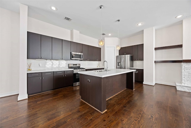 kitchen with stainless steel appliances, a sink, visible vents, open shelves, and light countertops