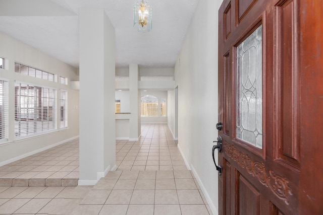 5442 Garden Village Dr, Kingwood, TX 77339 - foyer entrance with baseboards, an inviting chandelier, and light tile patterned flooring