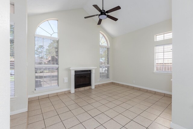 5442 Garden Village Dr, Kingwood, TX 77339 - unfurnished living room with high vaulted ceiling, light tile patterned floors, ceiling fan, a fireplace, and baseboards