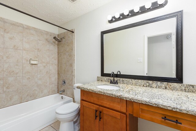 5442 Garden Village Dr, Kingwood, TX 77339 - full bathroom featuring washtub / shower combination, tile patterned floors, toilet, vanity, and a textured ceiling