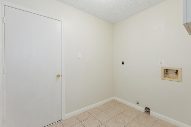 5442 Garden Village Dr, Kingwood, TX 77339 - laundry room with hookup for an electric dryer, baseboards, hookup for a washing machine, laundry area, and light tile patterned floors