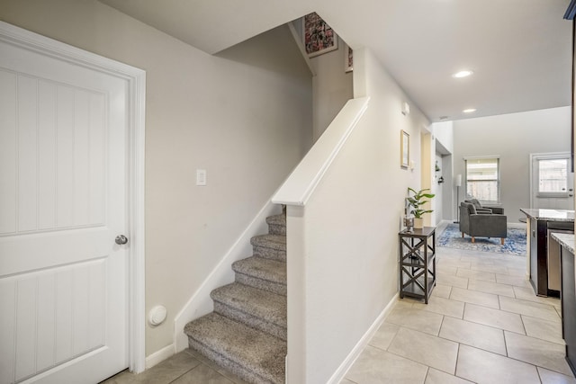 stairs featuring tile patterned floors, baseboards, and recessed lighting