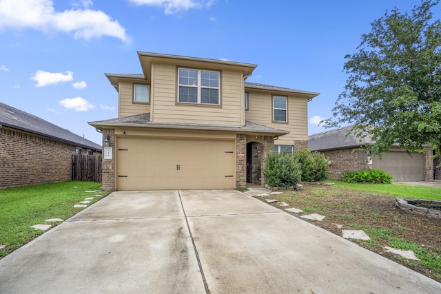 traditional-style house featuring a front lawn, driveway, fence, and a garage