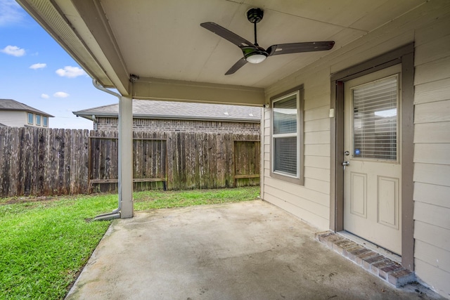 view of patio with fence and a ceiling fan