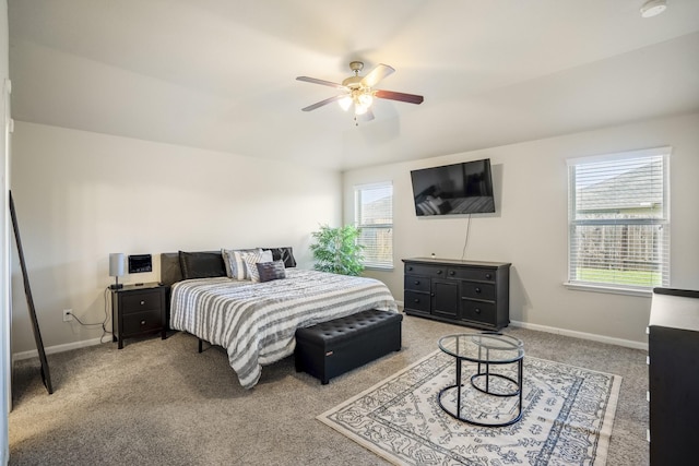 bedroom featuring light carpet, a ceiling fan, and baseboards