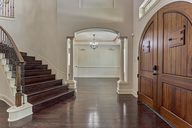 21411 Fairhaven Creek Dr, Cypress, TX 77433 - entryway with decorative columns, arched walkways, dark wood finished floors, stairs, and baseboards