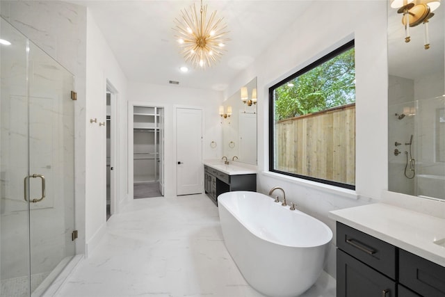 1957 Restridge Dr, Houston, TX 77055 - bathroom featuring a marble finish shower, marble finish floors, a chandelier, two vanities, and a soaking tub